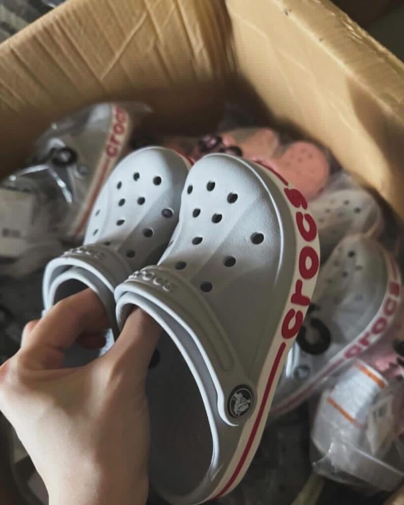 reseller inspecting Crocs pallets